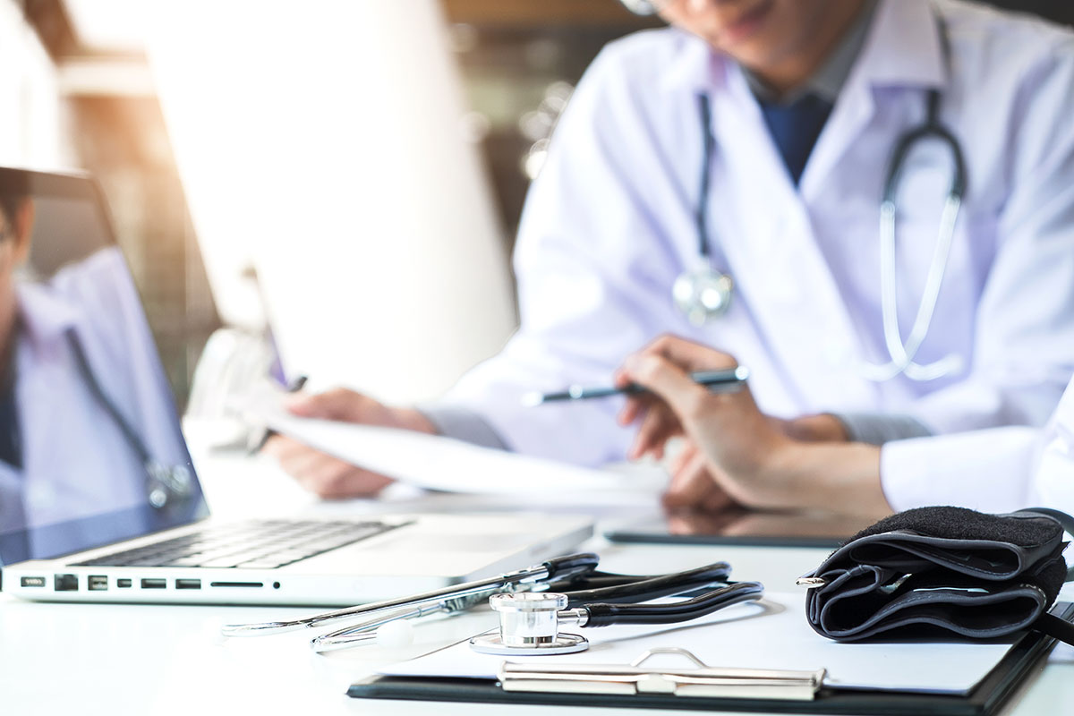 physician consultation working in front of laptop