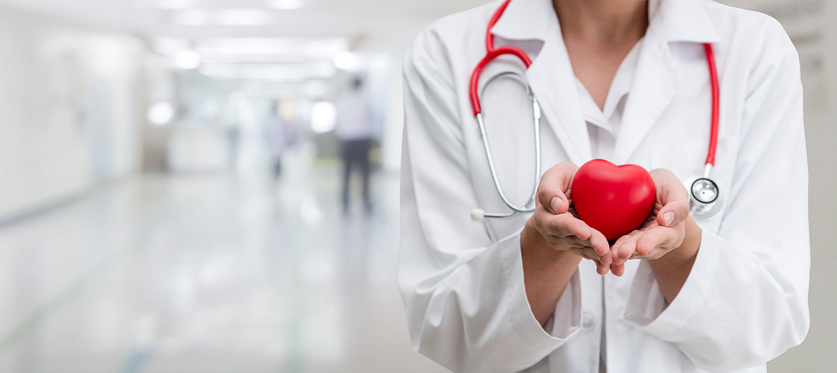 doctor holding heart. hospital hallway